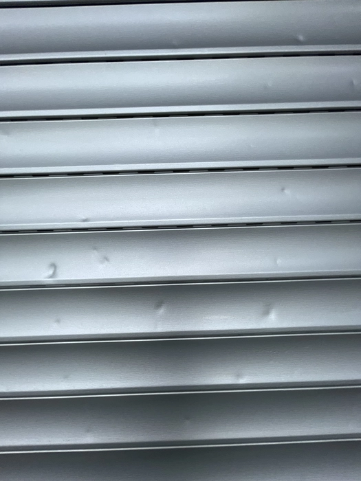 Dent in metal roller shutter (84652)